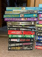 Stack of Anne Perry novels with additional titles visible