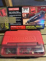 Retail box and red Craftsman rotary tool accessory case visible