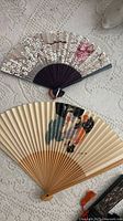 Cherry blossom and beige kimono dancer fans on lace surface