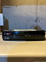 Front view of Dish Network Joey converter box showing branding, control buttons and LED window