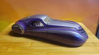 Left front three-quarter view of purple and silver Duesenberg Coupe Simone model