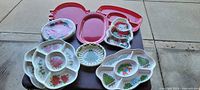 Assorted plastic holiday serving trays and platters with Christmas designs