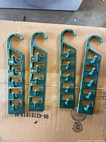 Four green plastic cascading closet organizers