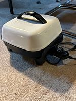 Presto electric skillet side view with white lid and cord