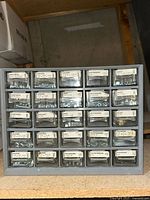 Front view of smaller organizer with 20 labelled drawers containing assorted screws and bolts