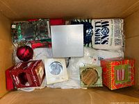 Box with ornaments, artificial snow, tinsel and fabric