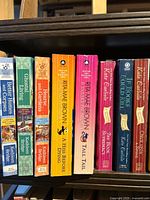 Row showing Better Homes and Corpses, Ghostal, Kate Carlisle titles and Rita Mae Brown titles