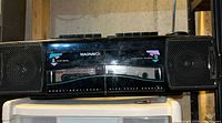 Front view showing Magnavox branding, twin cassette decks and speakers