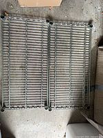 two loose wire shelves of unassembled unit