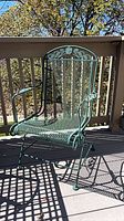 Green metal mesh patio armchair front view