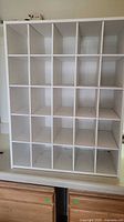 Front view of white 25-cubby organizer