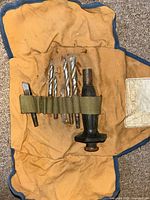 Canvas roll with drill bits, chisel, handle