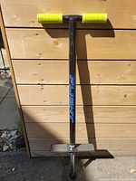 Front view showing the Flight branding in blue on the black frame, yellow handle grips, and metal foot pegs.