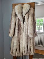 Front of full-length fur coat hanging showing shawl collar