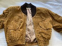 Full view of the Bart vintage suede bomber jacket laid flat showing polka dot pattern, front pockets, and zipper.