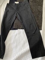 Black cotton pants by Marni laid flat, showing front side and waistband