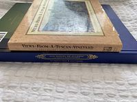 Side view photo showing 'Views From A Tuscan Vineyard' softcover and 'San Miguel de Allende' hardcover books stacked.