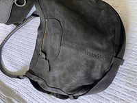 Roots hobo purse showing black soft leather with subtle suede texture and strap detail.