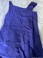 Full view of the purple Roland Mouret short dress showing fabric texture and wide shoulder straps.