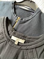 View of IRO 42 tag and Marni model tag at necklines