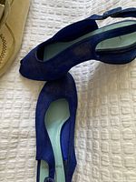 Top-down view of cobalt blue iridescent nubuck suede slingback shoes showing insole and open toe design