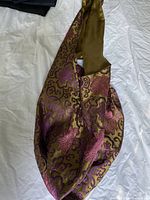 Photo shows satin hobo bag with olive green and purple decorative print