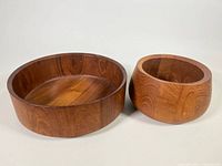 Front and side view of two teak salad bowls, larger one on left, smaller on right
