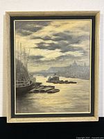 Full view of framed painting showing the river, boats, and sky scene.