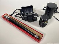 Full view of camera, lens, tripod, and cases