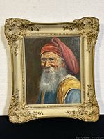 Full view of portrait painting in ornate wood frame