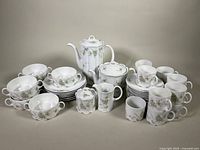 Full set of Rosenthal Classic Rose collection with teapot, coffee pot, creamer, sugar bowl, multiple cups and plates arranged on neutral background