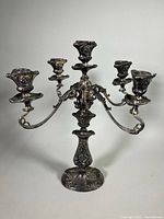 Front view of the silver plated candelabra showing five candle sockets and ornate arm structure.
