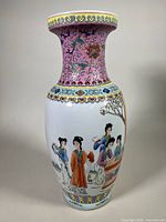 Front side of Famille Rose vase showing detailed painted figures in a garden scene under a pink neck with floral and abstract patterns.