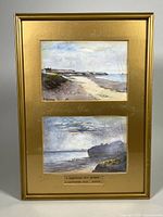 Front view of the gold wood frame containing the two watercolour paintings, showing the coastal scenes and overall condition.