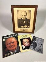 Photo showing all four items: framed Churchill portrait, softcover book, and two booklets.