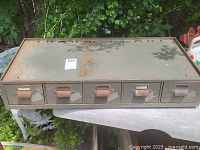 Full front view showing all five drawers and rusted handles with paper label holders.