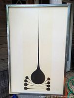 Framed Harold Town poster showing abstract black design on cream background, with artist signature and numbering visible at bottom edges.