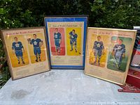 Three framed vintage Toronto Maple Leafs hockey player posters displayed together outdoors.