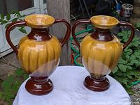 Pair of Beauceware ceramic vases on white cloth backdrop, showing both items together.
