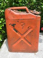 Front and side view of a single orange WW2 metal jerry can with visible wear and paint chipping, showing 'US' embossing and a handle on top