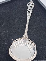 Full view of ornate 830 silver serving spoon