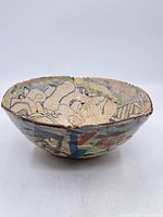 Top view of bowl showing interior figural design and crackle glaze