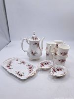 Complete coffee set showing coffee pot, tray, cups and dishes