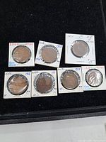 Group of seven Canadian large cent coins in flips