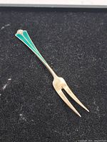 Full view of sterling two-prong fork on black background