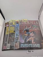 Five Eerie magazine issues in clear protective sleeves, standing upright showing front covers.