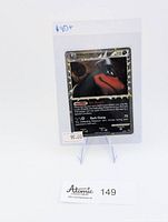 Card in protective sleeve displayed on stand with price sticker and Atomic Collectibles tag