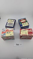 Four opened boxes of baseball cards from Fleer and Donruss, showing front and top views with handwritten year labels on the boxes