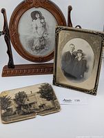 Main ornate faux wood swivel oval picture frame displaying a vintage portrait of a woman, plus the other two antique photographs in front.