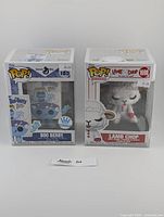 Front view of the two Funko Pop figures in boxes, showing Boo Berry on the left and Lamb Chop on the right, each with price stickers.